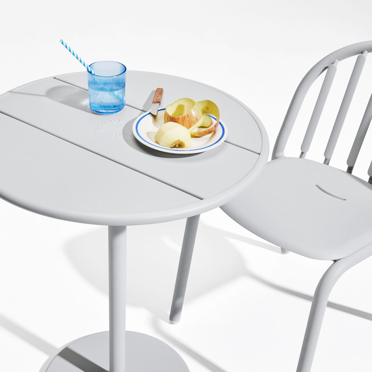 Fred&#39;s Bistro Set showcasing ergonomic chairs and a stable table, crafted for outdoor use in all weather conditions.