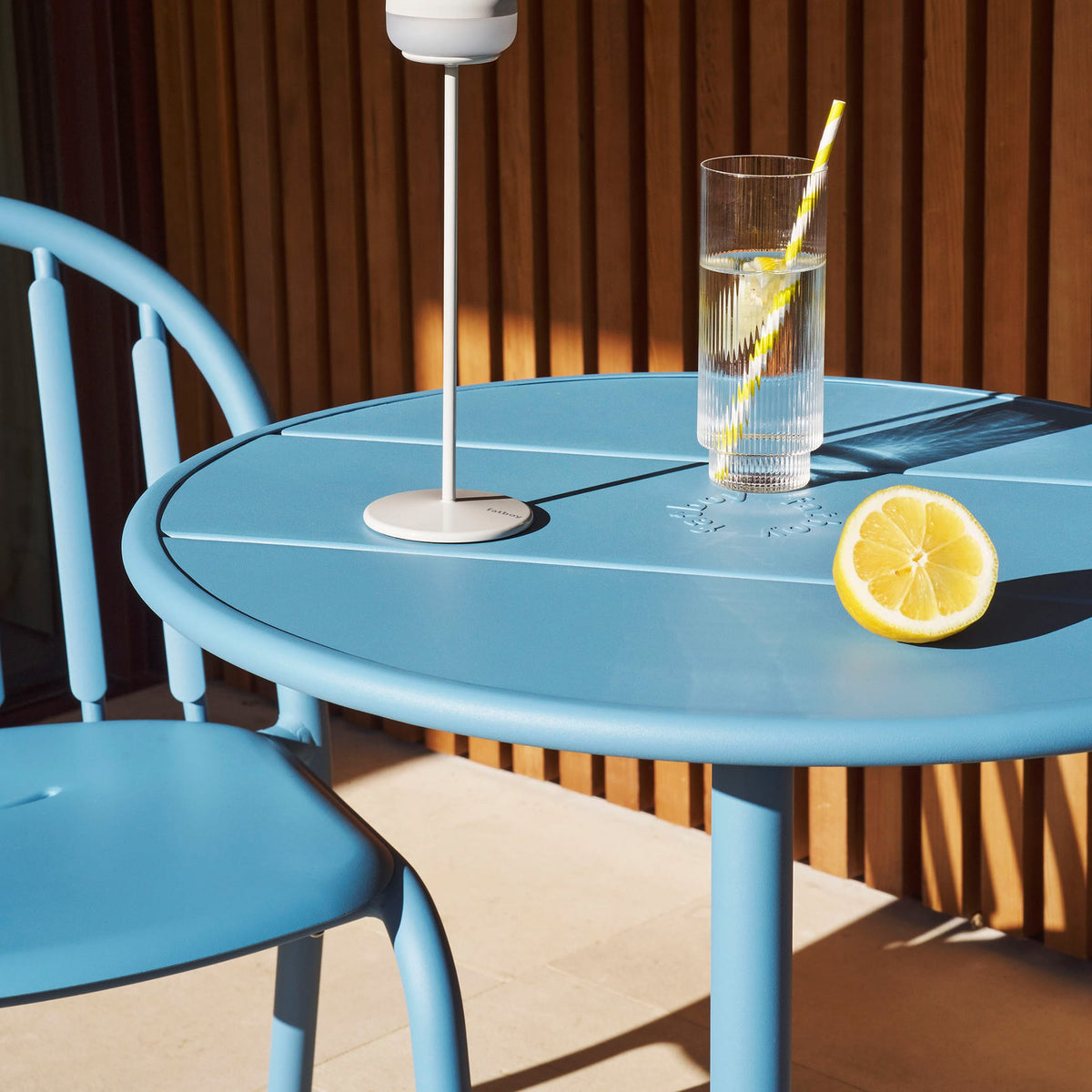 Fred&#39;s Bistro Set with a sturdy round table and stackable chairs, offering convenience and comfort for outdoor living.